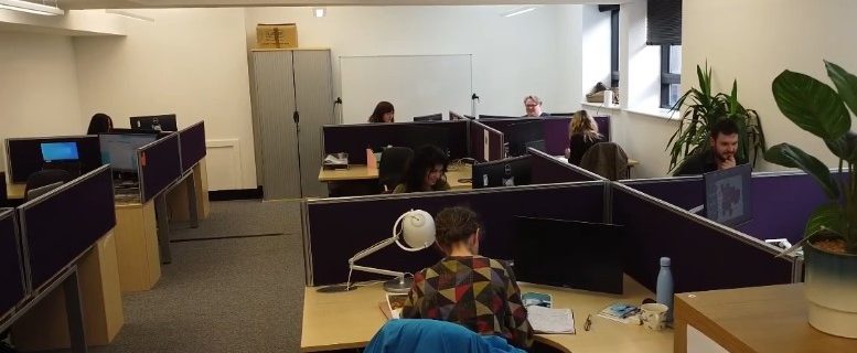 Charity office space furnished with recycled office chairs, office desks, and office storage