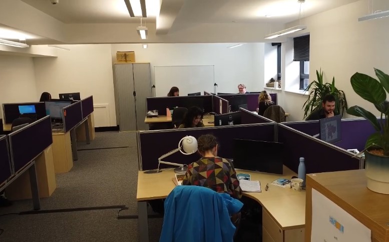 Charity office space furnished with recycled office chairs, office desks, and office storage